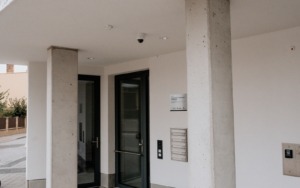 Betonové sloupy tvořící krytý vstup do polyfunkčního domu ve Šlapanicích.